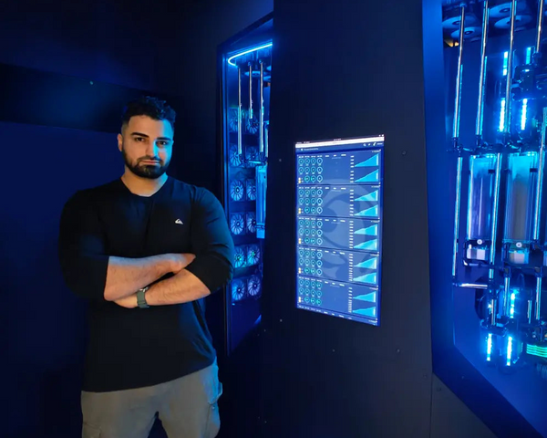 Founder of Alpha PC, Dillon Mamiza, standing in front of his AI Supercomputer build named WALLACE, built for a Toronto Hedge fund named Castle Ridge Asset Management