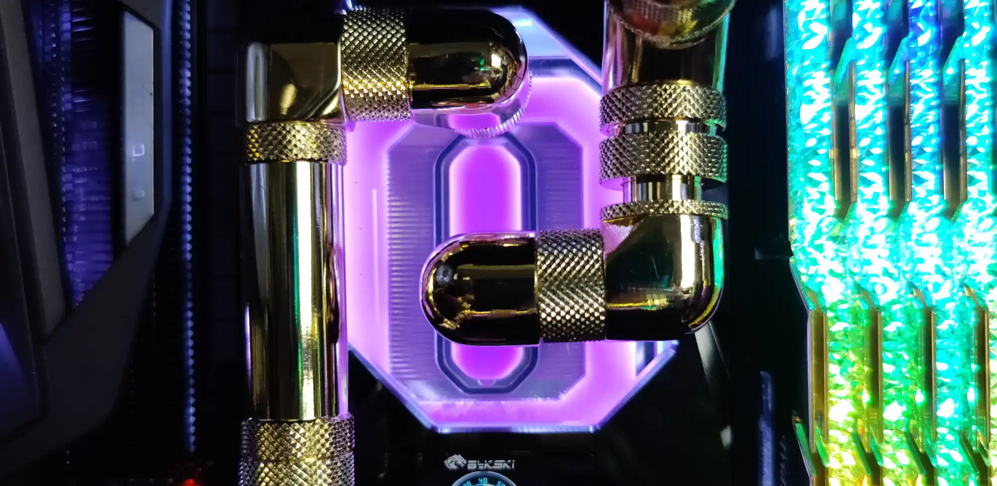 High‑end custom PC liquid‑cooling hardware with RGB‑lit tubing and metal fittings, built by Alpha PC—the top custom PC builder in Toronto.