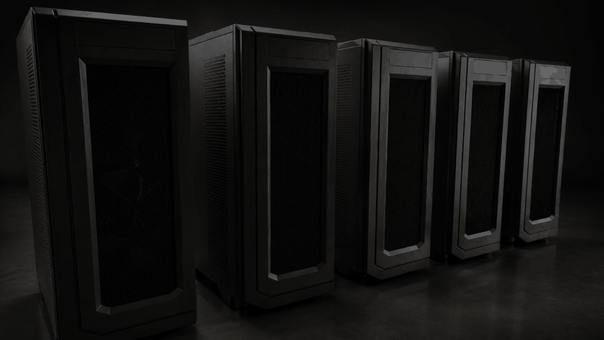 Five black computer server towers with silver trim are lined up in a row against a dark studio background.
