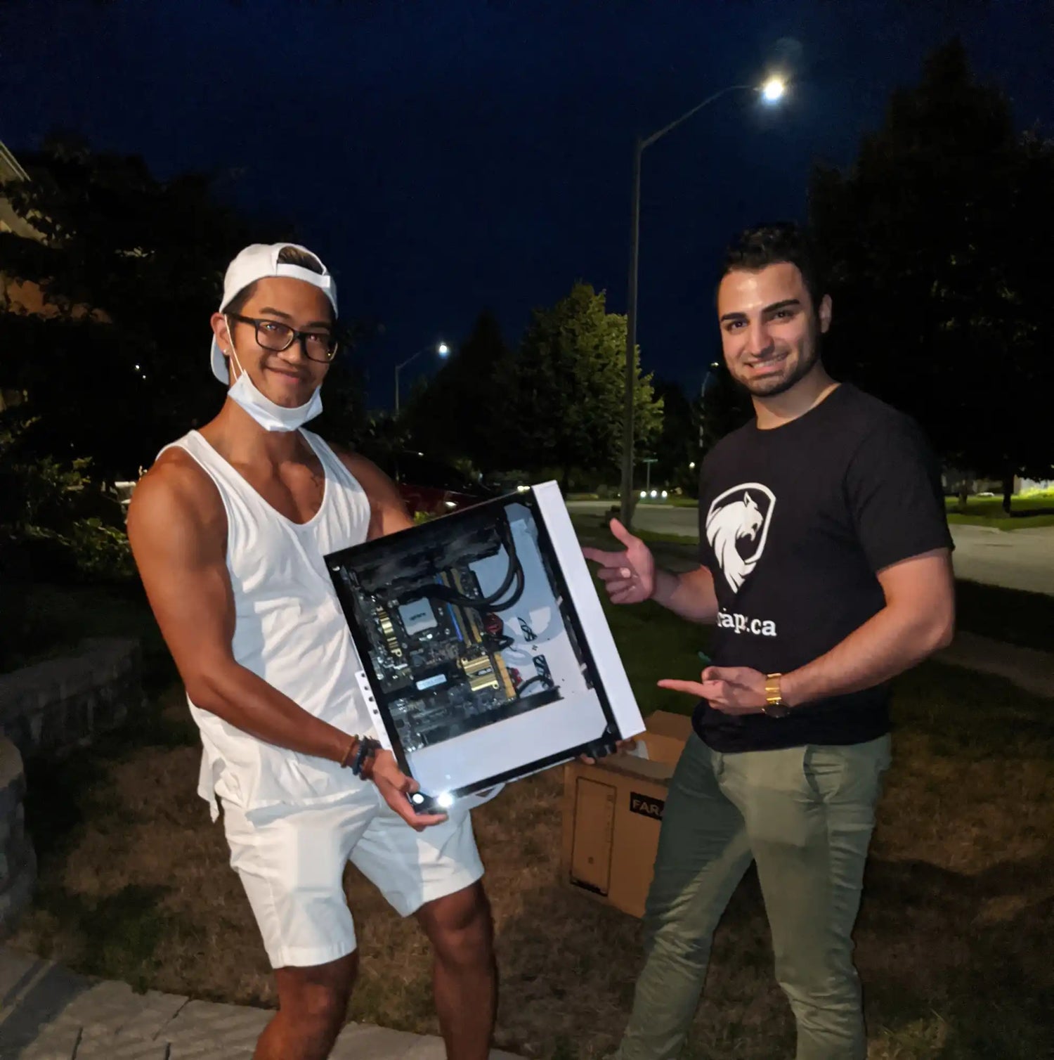 Photo of Dillon from Alpha PC presenting a liquid‑cooled custom PC build to a happy client in Toronto, reflecting our origin story and expertise in custom PC design